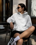 XEMORIX Signature Hoodie in heather gray worn by model with centered logo, premium casual streetwear look