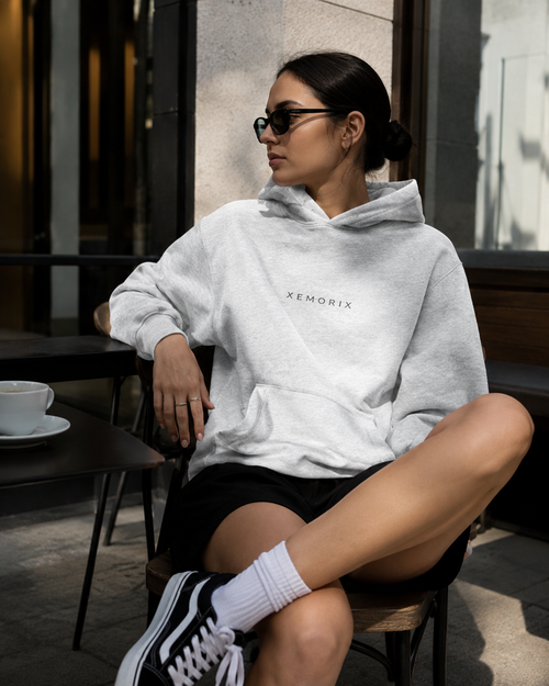 XEMORIX Signature Hoodie in heather gray worn by model with centered logo, premium casual streetwear look