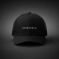 XEMORIX XMRX-015 Signature Cap in Black with centered front wordmark on a dark premium background