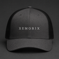XEMORIX XMRX-022 Signature Cap in Charcoal Black with centered front wordmark on a dark premium background