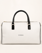 XEMORIX white and black signature weekender bag with centered logo, structured silhouette, and refined luxury travel design
