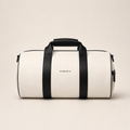 White and black XEMORIX Signature Duffel Bag with centered logo, black straps, zipper pocket, and luxury travel design.