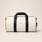 White and black XEMORIX Signature Duffel Bag with centered logo, black straps, zipper pocket, and luxury travel design.