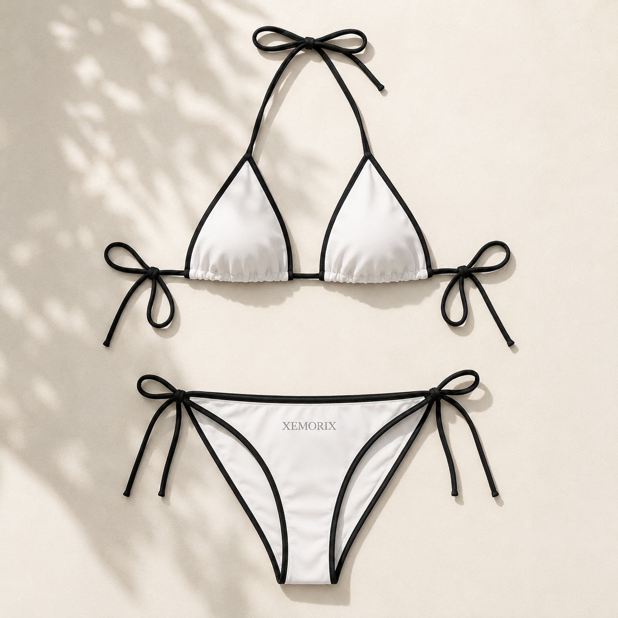 White and black XEMORIX bikini set with minimalist contrast trim, luxury resort styling, and premium poolside look.
