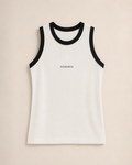 XEMORIX XMRX-050 white sleeveless ribbed tank top with black trim and centered logo on beige luxury background