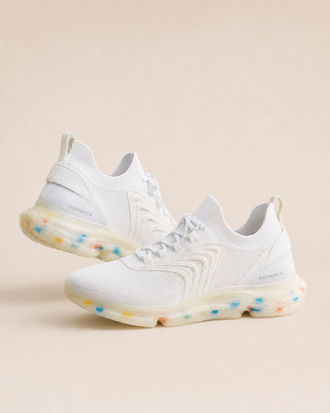 XEMORIX XMRX-071 Signature Motion Sneaker in white with a translucent sole and subtle side logo on a beige luxury studio background.