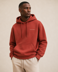 XEMORIX XMRX-044 terracotta minimalist hoodie with left chest logo on a beige luxury background