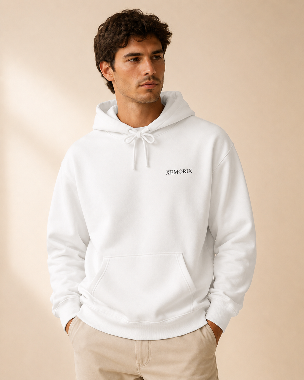 XEMORIX XMRX-076 white minimalist hoodie with left chest logo and branded neck label on a beige luxury background